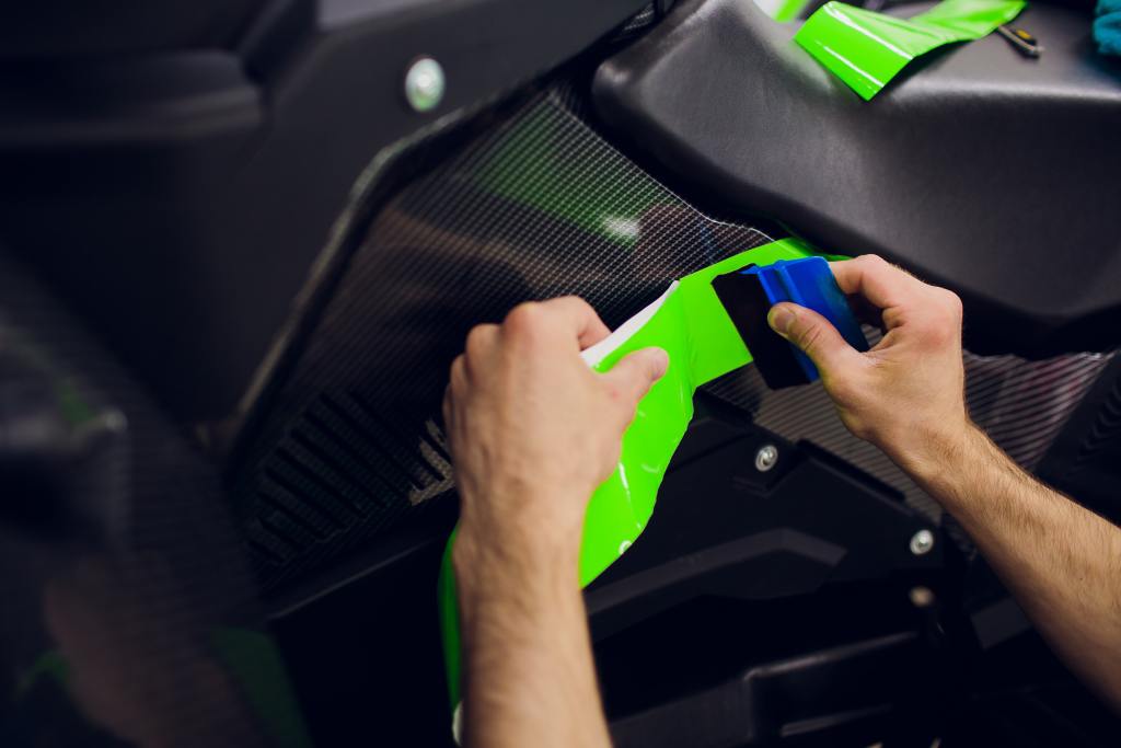 Car ATV wrapping specialists wrapping vehicle with green vinyl film or foil